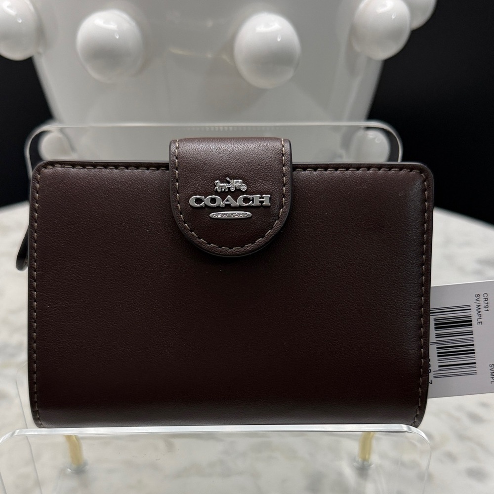 Coach Dark Brown Leather Wallet with gold hardware.
